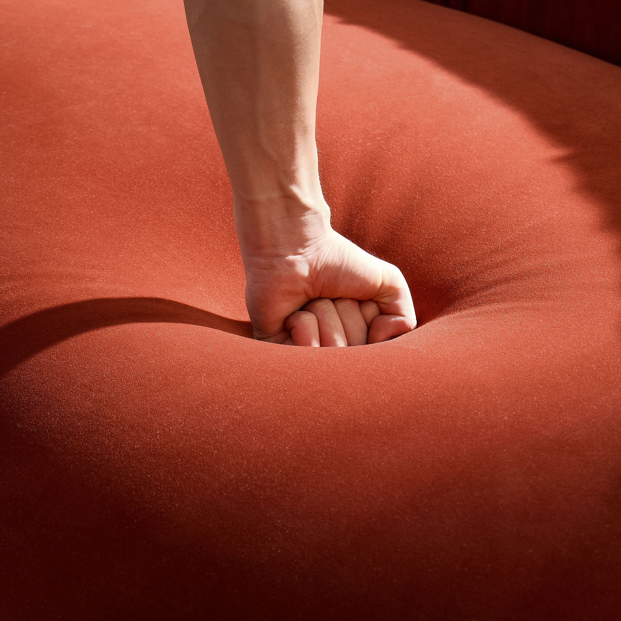 Modern Curved Sofa with Elegant Crescent Silhouette in Orange-Red