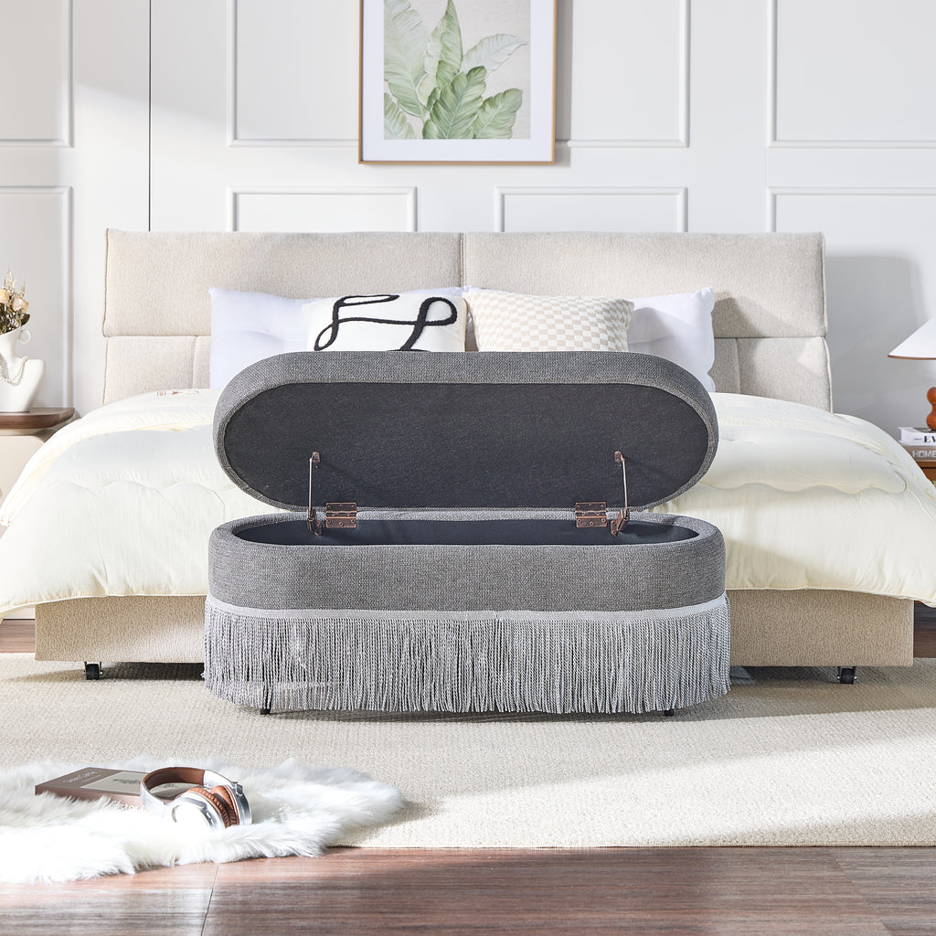 Oval Upholstered Storage Ottoman with Fringe Trim & Lift-Top Lid