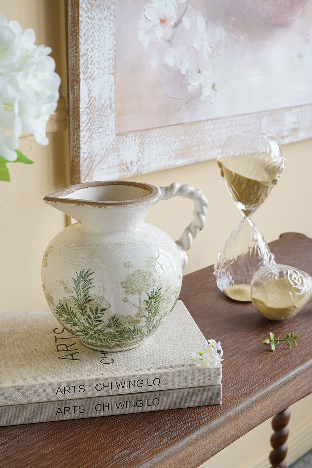 White Ceramic Pitcher Vase with Green Botanical Motifs and Twisted Handle